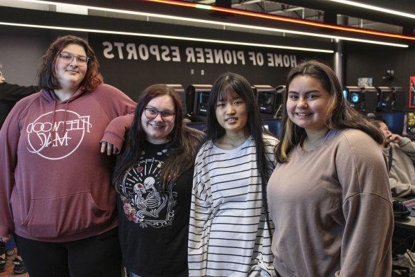 The four members of the first all-female eSports team at Utica University stands shoulder to shouler.